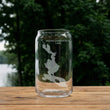 Load image into Gallery viewer, A clear glass can with a map of Mooselookmechanic Lake printed on it, placed on a wooden surface.
