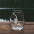 Load image into Gallery viewer, A wine glass with a map of Mooselookmeguntic Lake printed on it, placed on a wooden table.
